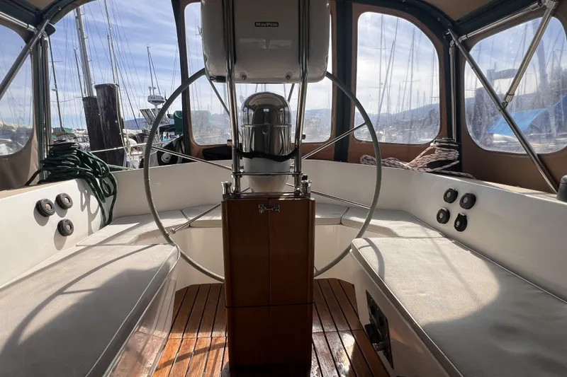 Slide: The Image of Interior view of a 1991 Perry 51 sailboat cockpit with steering wheel and seating. - 37