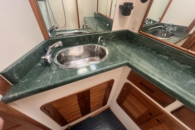 Slide: The Image of Luxurious bathroom with green marble countertop in 1991 Perry 51 yacht. - 92