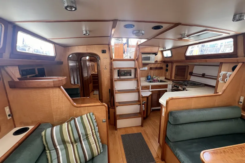 Slide: The Image of Interior of a 1991 Perry 51 yacht featuring a cozy kitchen and seating area. - 53
