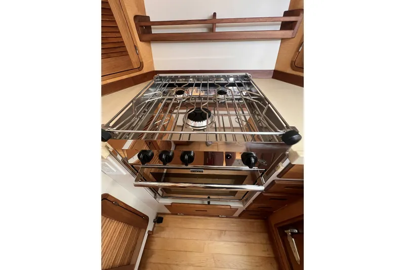 Slide: The Image of Stainless steel stove in a 1991 Perry 51 yacht kitchen, featuring wooden cabinetry. - 57