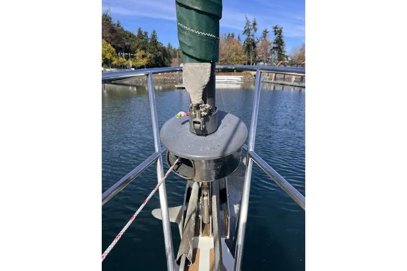 Slide: The Image of Bow of 1991 Perry 51 sailboat with stainless steel railing and calm water backdrop. - 13