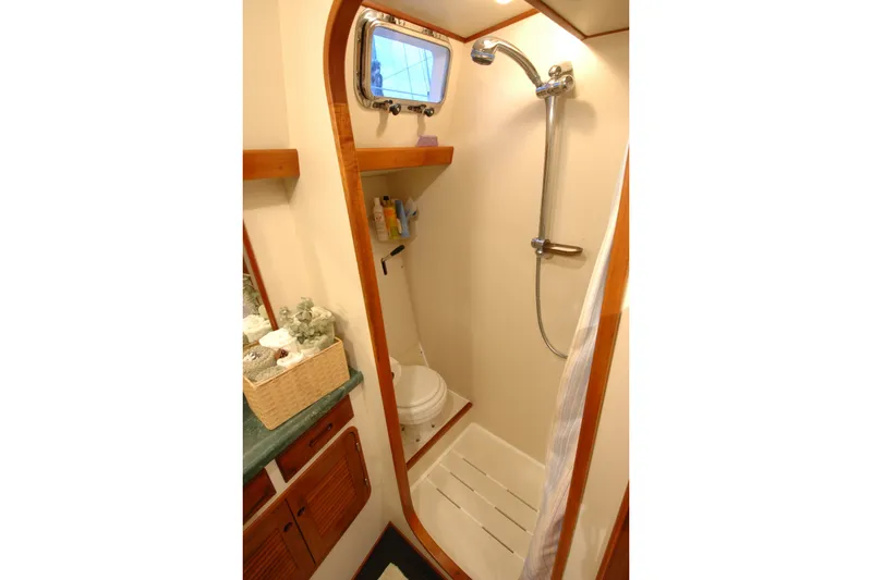 Slide: The Image of Compact bathroom in 1991 Perry 51 yacht with shower and wooden accents. - 82