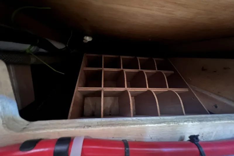 Slide: The Image of Wooden storage compartment inside a 1991 Perry 51 boat, featuring multiple sections. - 110