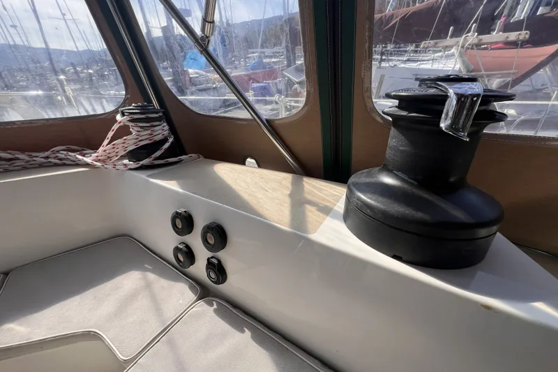 Slide: The Image of Interior of a 1991 Perry 51 sailboat, featuring winches and ropes in the cockpit area. - 44
