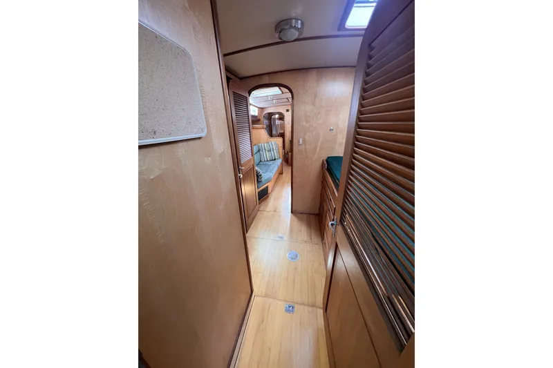 Slide: The Image of Interior of 1991 Perry 51 yacht with wooden paneling and cozy seating area. - 85