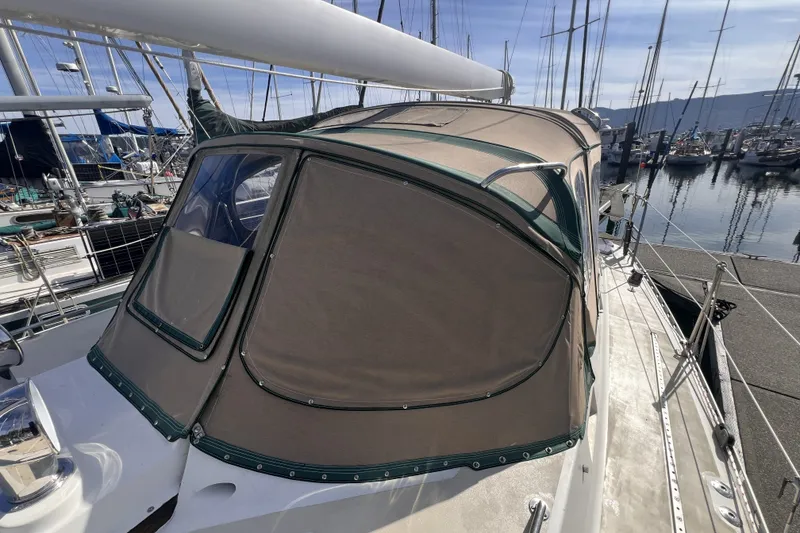Slide: The Image of Sailboat Perry 51 (1991) with beige canopy docked at marina. - 26