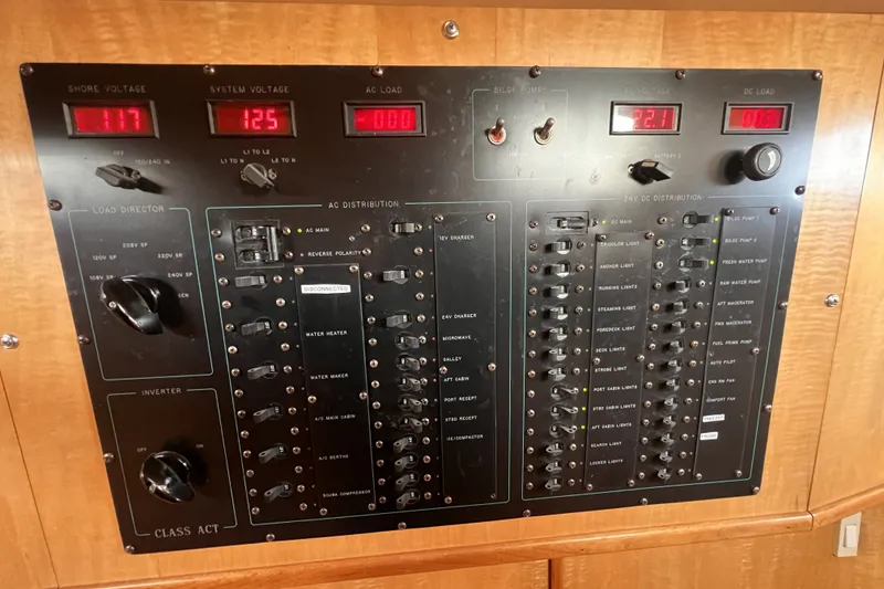 Slide: The Image of Electrical control panel on a 1991 Perry 51 yacht, displaying voltage and load indicators. - 74