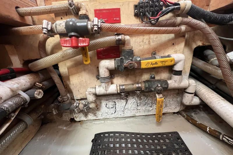 Slide: The Image of Plumbing system with valves and hoses in a 1991 Perry 51 boat. - 109