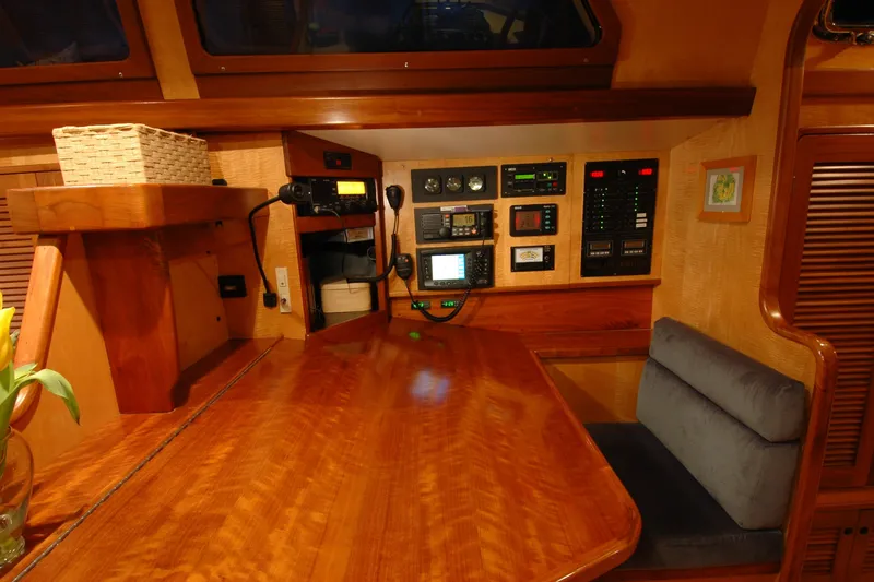Slide: The Image of Navigation station in a 1991 Perry 51 yacht with control panels and seating. - 70