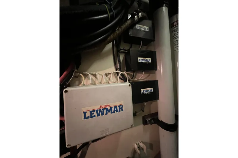 Slide: The Image of Electrical system components labeled "Lewmar" inside a 1991 Perry 51 model. - 104