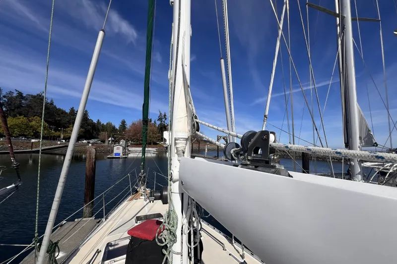 Slide: The Image of Sailboat Perry 51, 1991 model, docked at marina under clear blue sky. - 31