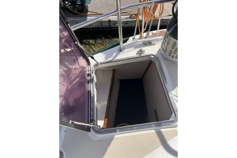 Slide: The Image of Open hatch on 1991 Perry 51 boat deck, revealing interior access. - 47