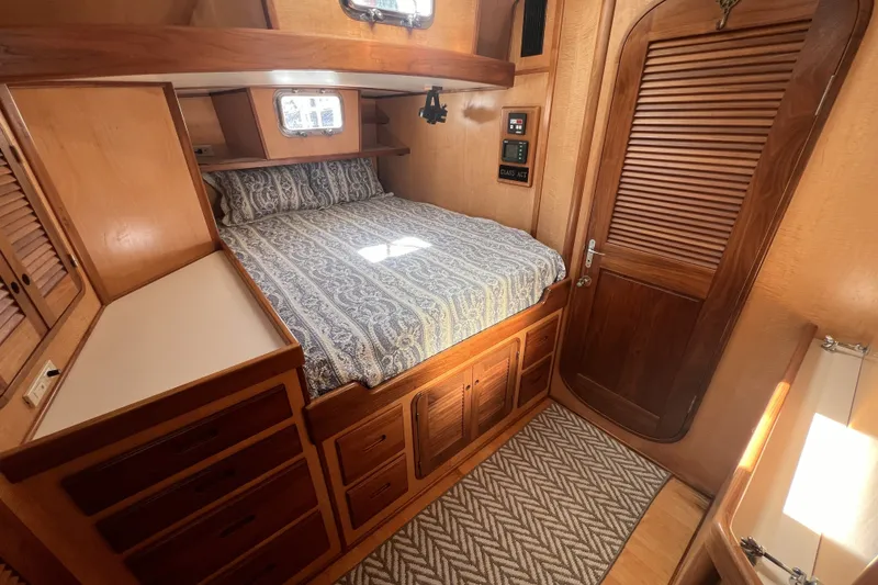 Slide: The Image of Cozy wooden cabin interior of 1991 Perry 51 yacht with bed and storage. - 76