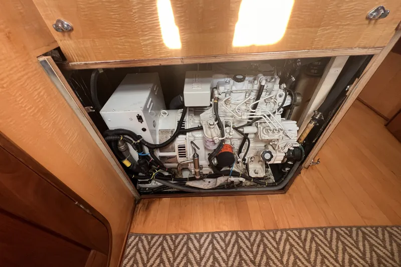 Slide: The Image of Engine compartment of a 1991 Perry 51, showcasing mechanical components and wiring. - 107