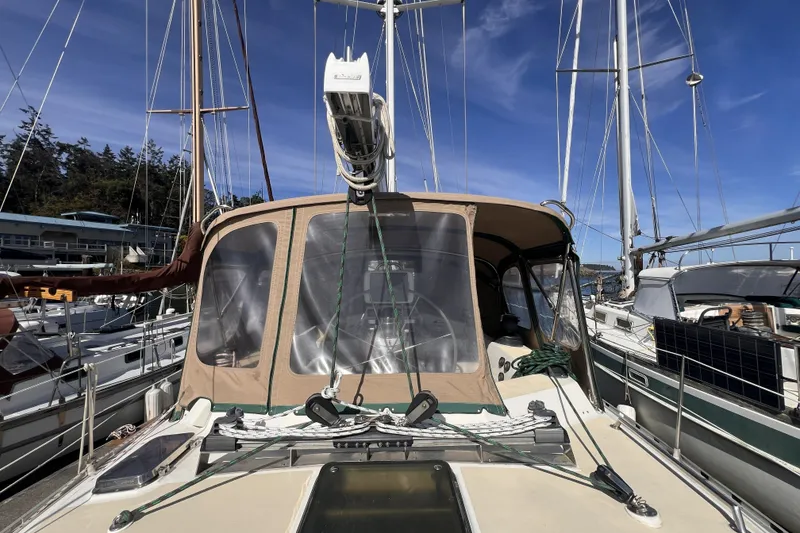 Slide: The Image of Sailboat Perry 51, 1991 model, docked at marina under clear blue sky. - 29