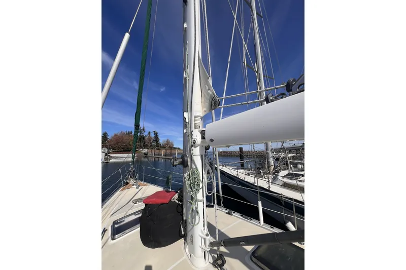 Slide: The Image of Sailboat deck view of 1991 Perry 51, featuring mast and rigging under clear blue sky. - 30