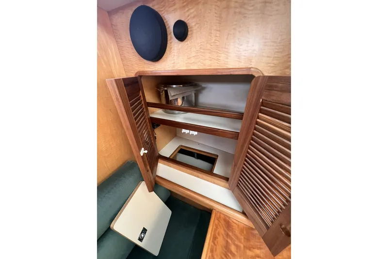 Slide: The Image of Wooden cabinet interior on a 1991 Perry 51 boat, featuring shelves and storage space. - 65