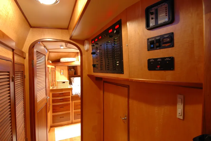 Slide: The Image of Luxurious wooden interior of a 1991 Perry 51 yacht, featuring control panels and storage cabinets. - 73