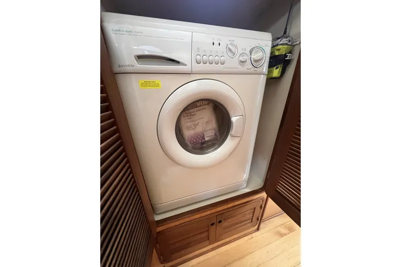 Slide: The Image of Front-loading washing machine, Perry 51 model, 1991, in a wooden cabinet setting. - 75