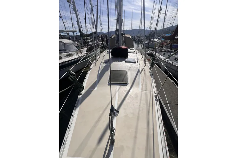 Slide: The Image of Sailboat deck view of 1991 Perry 51, docked in a marina under clear skies. - 17