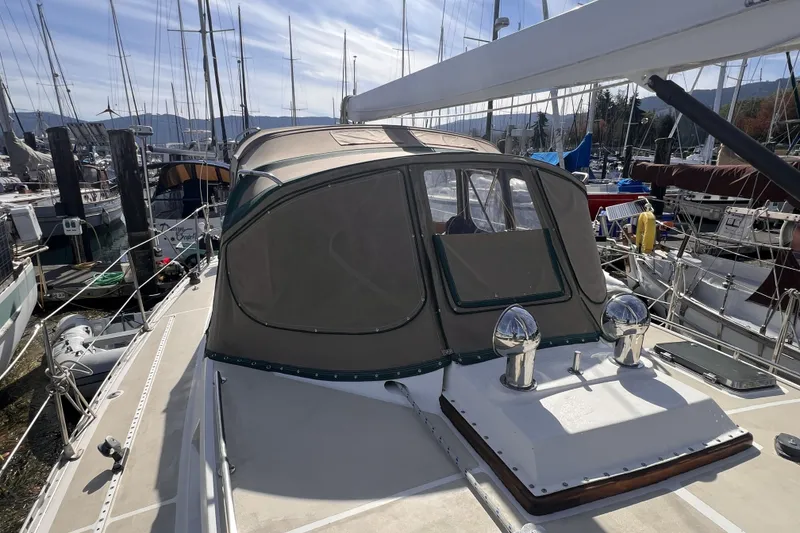 Slide: The Image of Sailboat Perry 51, 1991 model, docked at marina with covered cockpit and clear sky. - 28