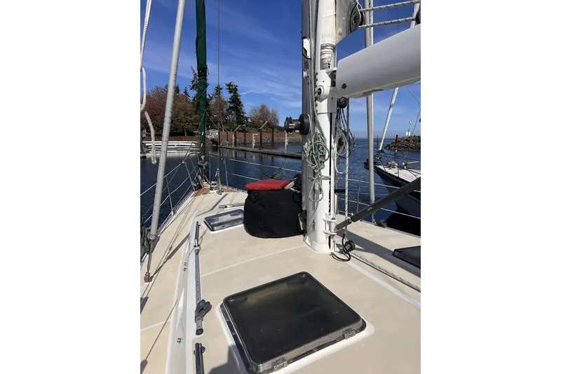 Slide: The Image of Sailboat deck view, Perry 51 model, 1991, docked near trees and calm water. - 22