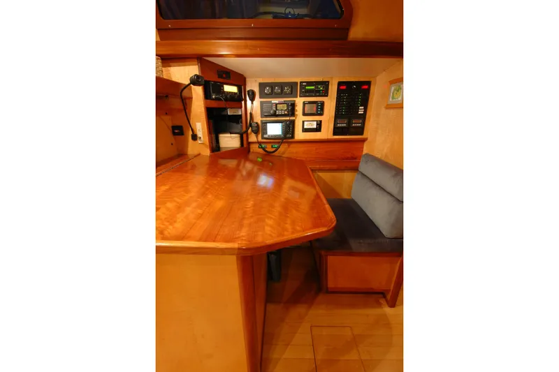 Slide: The Image of Navigation station in a 1991 Perry 51 yacht, featuring wooden desk and control panels. - 66