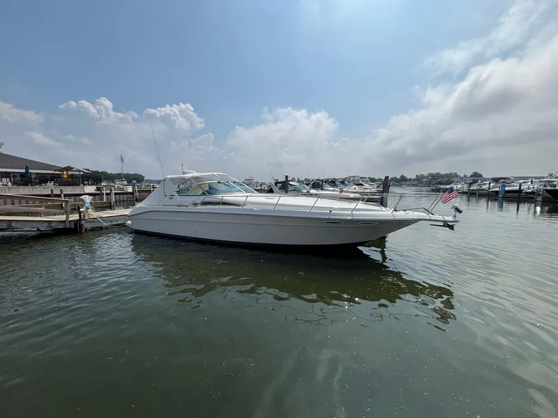 The Image of 1992 Sea Ray 400 EXPRESS yacht docked at marina under cloudy sky. - 0