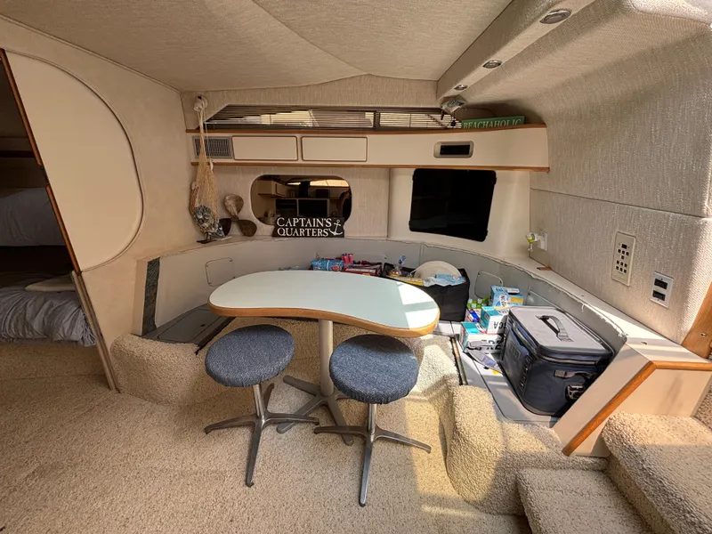 Slide: The Image of Interior of 1992 Sea Ray 400 EXPRESS yacht with dining area and storage. - 18