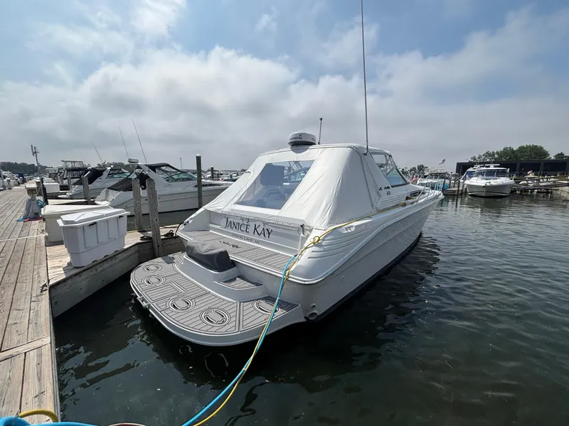 Slide: The Image of 1992 Sea Ray 400 EXPRESS docked at marina under cloudy sky. - 2