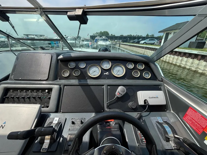 Slide: The Image of Cockpit view of a 1992 Sea Ray 400 EXPRESS with gauges and Garmin device. - 11