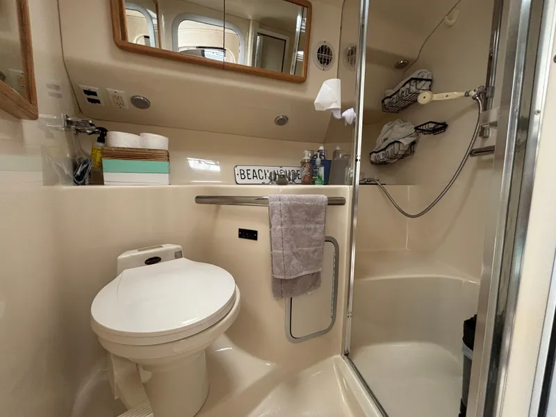 Slide: The Image of Bathroom interior of 1992 Sea Ray 400 EXPRESS yacht, featuring shower and toilet. - 21