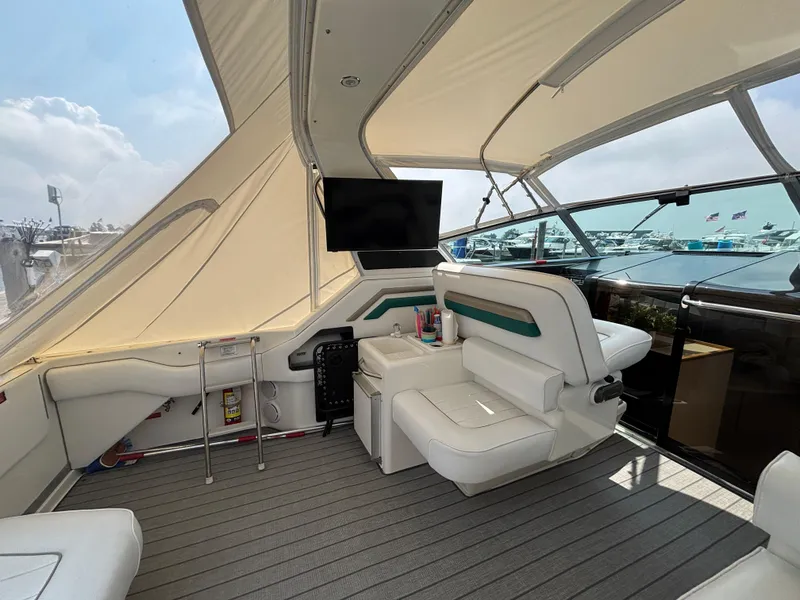 Slide: The Image of Interior of 1992 Sea Ray 400 EXPRESS yacht with seating and TV, docked at marina. - 7