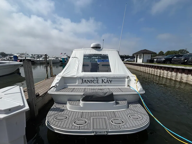 Slide: The Image of 1992 Sea Ray 400 EXPRESS docked at marina, rear view with custom name "Janice Kay." - 3
