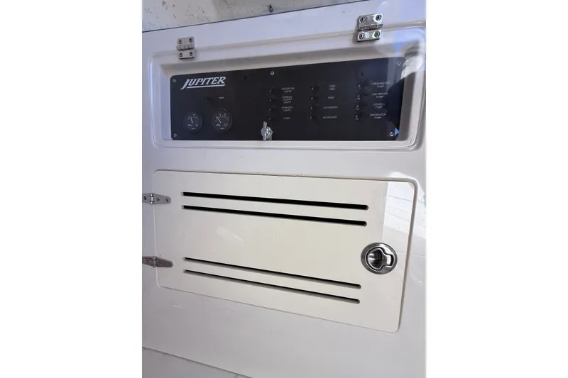 Slide: The Image of Control panel of a 2015 Jupiter 34 FS boat, featuring gauges and switches. - 18