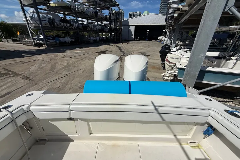 Slide: The Image of 2015 Jupiter 34 FS boat in marina storage, featuring dual outboard motors. - 28