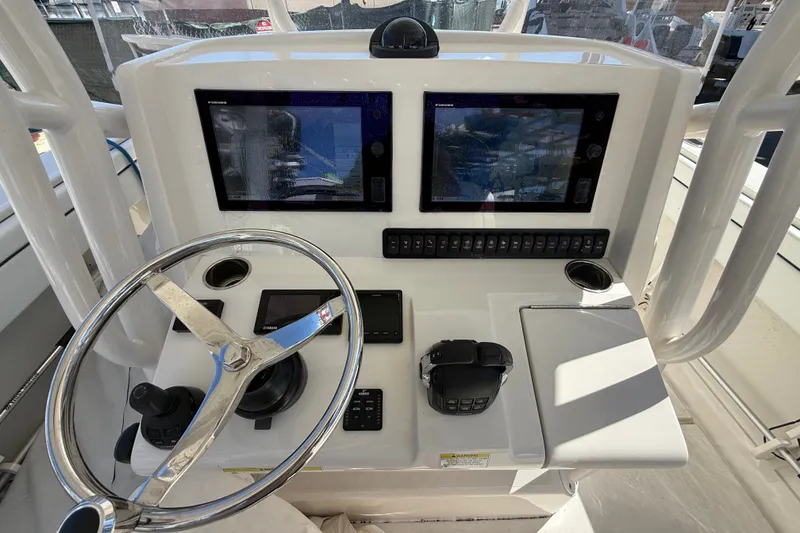 Slide: The Image of Helm of 2015 Jupiter 34 FS boat with dual displays and steering wheel. - 33