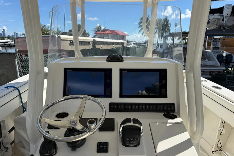 Slide: The Image of 2015 Jupiter 34 FS boat dashboard with dual screens and steering wheel. - 16