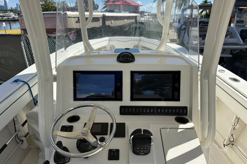 Slide: The Image of Helm of 2015 Jupiter 34 FS boat with dual screens and steering wheel. - 17