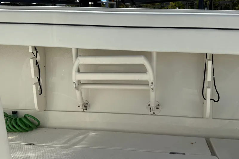 Slide: The Image of 2015 Jupiter 34 FS boat ladder and deck with coiled green hose. - 30