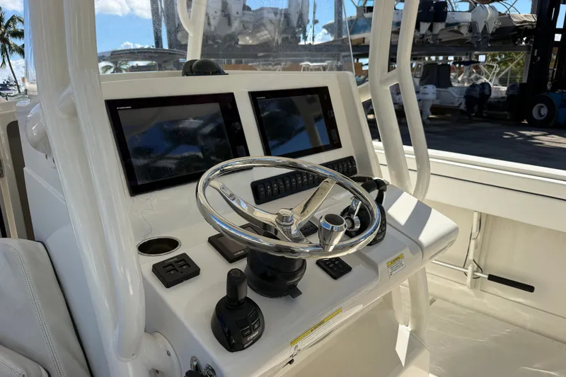 Slide: The Image of Helm of 2015 Jupiter 34 FS boat with dual screens and steering wheel. - 35