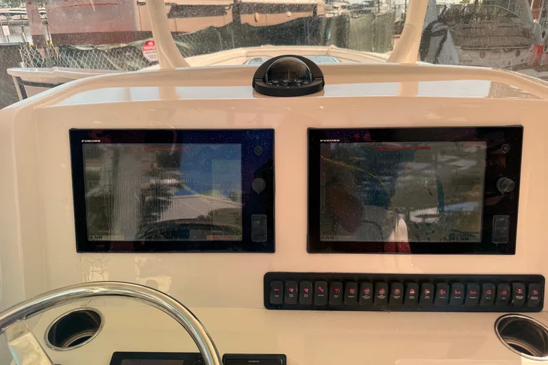 Slide: The Image of Dashboard of 2015 Jupiter 34 FS boat with dual navigation screens. - 34