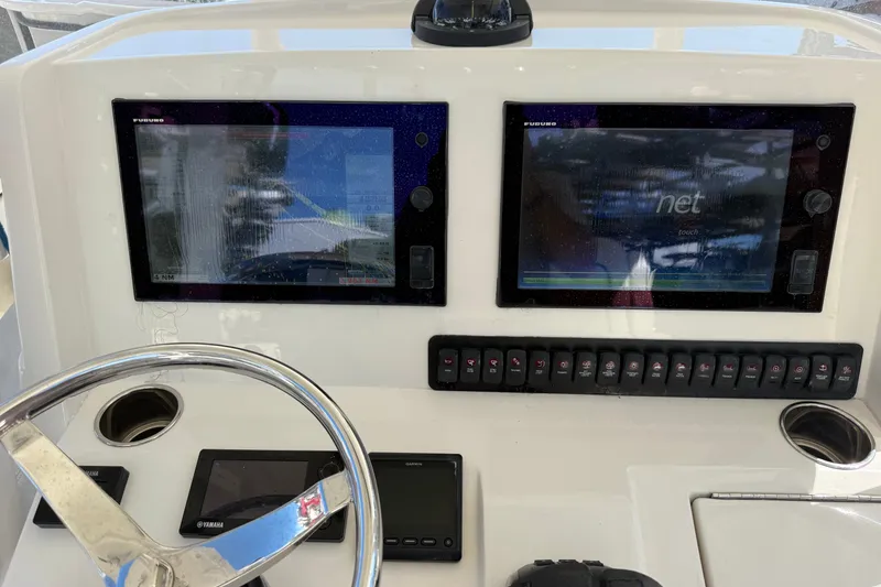 Slide: The Image of Control panel of a 2015 Jupiter 34 FS boat with dual navigation screens. - 32