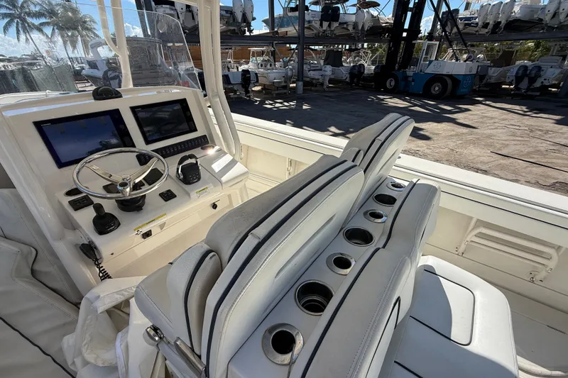 Slide: The Image of 2015 Jupiter 34 FS boat cockpit with dual screens and white seating. - 36