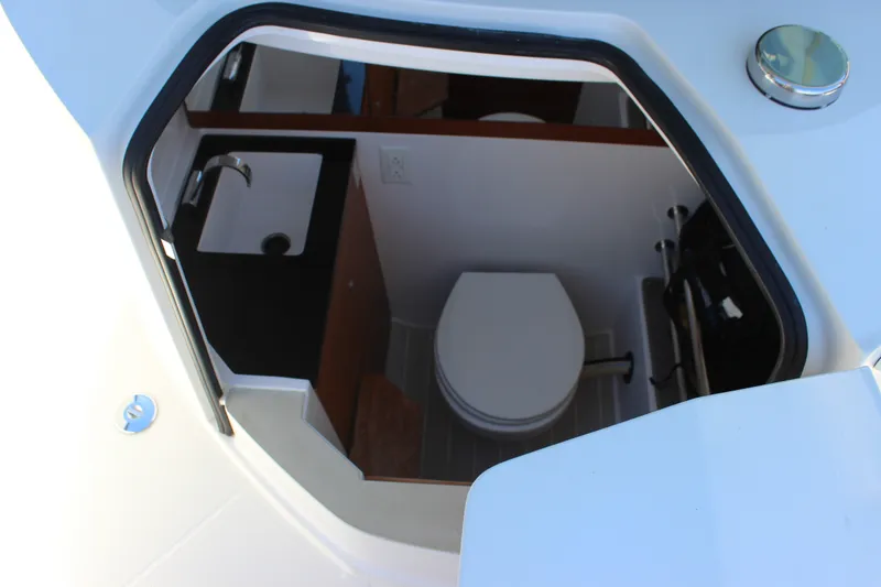 Slide: The Image of Interior view of 2019 Axopar Brabus 28 Cabin boat bathroom with sink and toilet. - 14