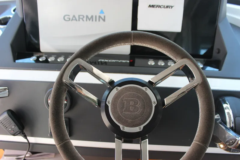 Slide: The Image of Steering wheel of 2019 Axopar Brabus 28 Cabin with Garmin and Mercury displays. - 15