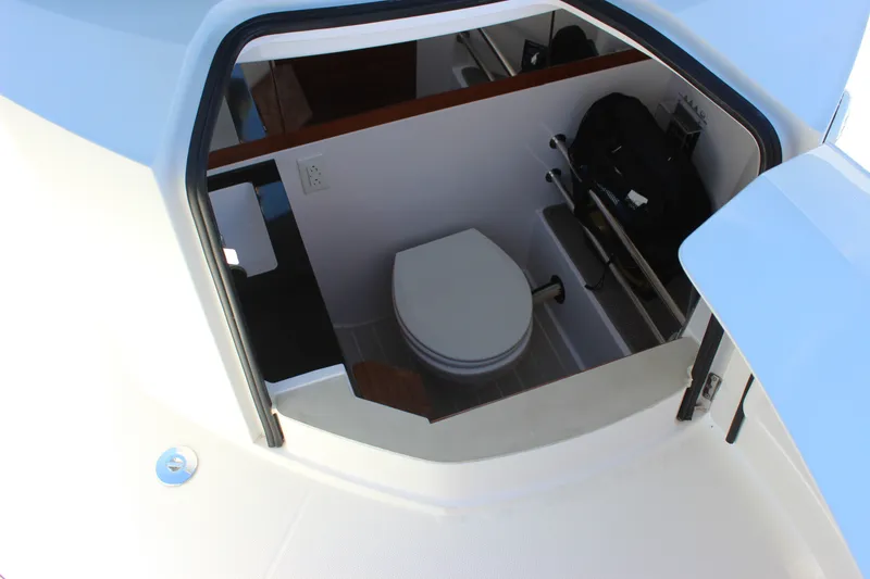 Slide: The Image of Interior view of 2019 Axopar Brabus 28 Cabin boat's compact bathroom. - 13