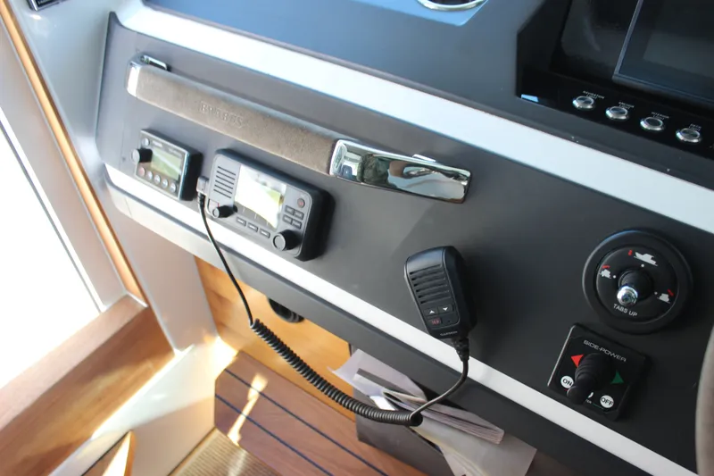 Slide: The Image of Control panel of a 2019 Axopar Brabus 28 Cabin boat with communication equipment. - 17
