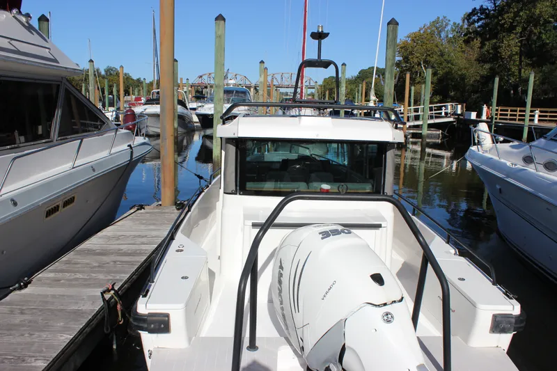 Slide: The Image of 2019 Axopar Brabus 28 Cabin boat docked at marina with outboard motor. - 21