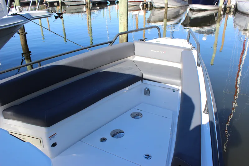 Slide: The Image of 2019 Axopar Brabus 28 Cabin boat docked, featuring sleek seating and modern design. - 1